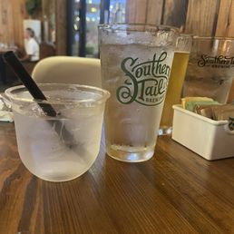 Plastic cup from the bar with a branded glass cup.