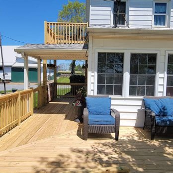 Laughner Contracting Services - a deck with chairs and a table - General Contractors Near Me