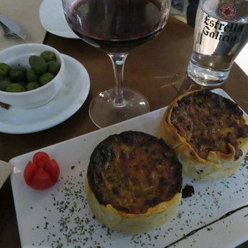 Tinto y Tapas - Cheese and onion empanada, wine, and complimentary olives - Tapas Bars Near Me - Madrid, M Tinto y Tapas - Cheese and onion empanada, wine, and complimentary olives - Tapas Bars Near Me - Madrid, M