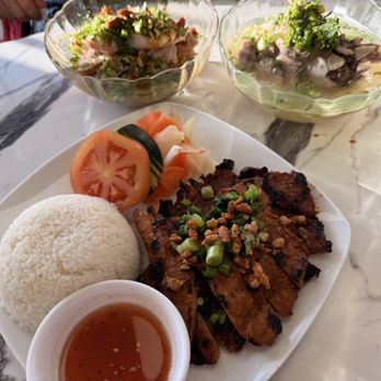 Danh’s Kitchen - Pork chop with broken rice (front) and Hu Tiu Num Vang with soup on the side. - Vietnamese Near Me - Portland, Oregon Danh’s Kitchen - Pork chop with broken rice (front) and Hu Tiu Num Vang with soup on the side. - Vietnamese Near Me - Portland, Oregon