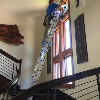 Clear Choice Window Cleaning - London using a ladder inside a large house to window cleaning in Grants Pass, OR - Window Washing Near Me - Medford, Oregon