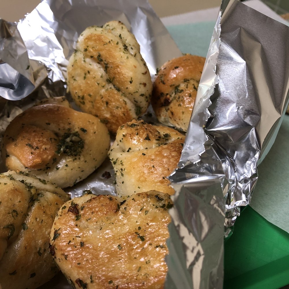 a bunch of bread rolls wrapped in tin foil