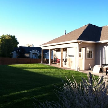 Lush Green Landscapes - a backyard with a lawn and a house in the background - Landscaping Near Me - Palisade, Colorado Lush Green Landscapes - a backyard with a lawn and a house in the background - Landscaping Near Me - Palisade, Colorado