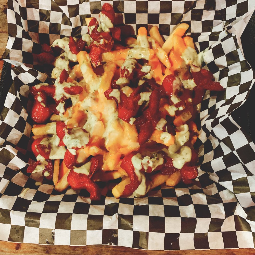 Salchi papa's. Fries with ketchup and mayo and creamy garlic sauce with cut up hot dogs.