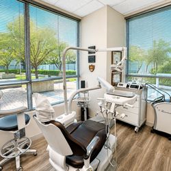IMPrESS Perio Implant Center - Modern treatment suite featuring advanced implant and periodontal technology, laser dentistry, and abundant natural light