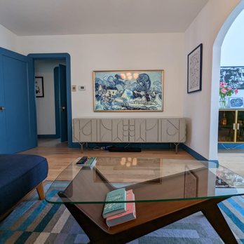 Heirloom Builders - a living room with a blue couch and coffee table - General Contractors Near Me - San Francisco, California
