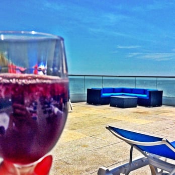 Allegria Hotel - Rooftop pool view of ocean with wine in hand - Hotels Near Me - Long Beach, New York Allegria Hotel - Rooftop pool view of ocean with wine in hand - Hotels Near Me - Long Beach, New York