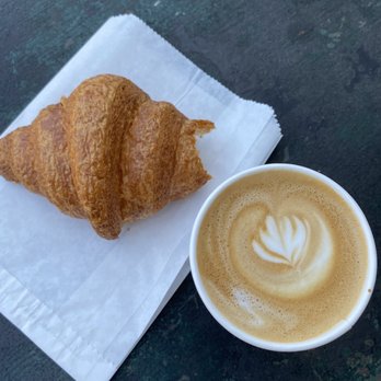 All City Coffee - Bitten into-plain croissant and 8oz. Latte - Coffee & Tea Near Me - Seattle, Washington