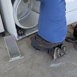 Zack working hard on the broken dryer. Zack working hard on the broken dryer.