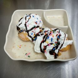 Mango Mochi topped with whipped cream chocolate drizzle and sprinkles