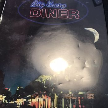 Big Easy Diner - The menu cover displays a night scene with a large, bright moon and a crescent moon in the sky. The background includes a city street with illuminated signs, including one for jazz and bourbon. The top of the menu shows the name 'Big Easy Diner' in neon-style text, with 'Big Easy' in blue and 'Diner' in pink. The overall design suggests a nighttime atmosphere with a focus on a lively, urban setting. - American Near Me - Slidell, Louisiana