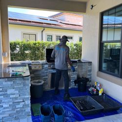 Grilltor - BBQ Grill Care - Grill cleaning technician in action.