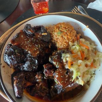 Dasha Barbour's - Smoked oxtails served with seasoned rice and sautéed cabbage - Southern Near Me - Louisville, Kentucky Dasha Barbour's - Smoked oxtails served with seasoned rice and sautéed cabbage - Southern Near Me - Louisville, Kentucky