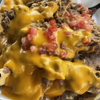 Taco Casa Hutto - Super Nachos- ground beef, nacho cheese, fresh diced tomatoes. Also comes with sour cream and Jalapeño's - Mexican Near Me - Hutto, Texas