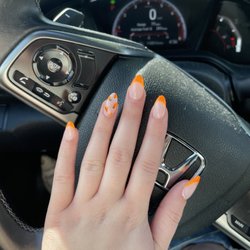 Fashion Nail HL - Almond shaped nails with orange tips and tangerines on the ring finger's nail.
