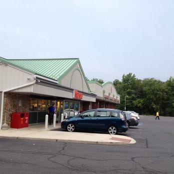 Wawa - a car parked in front of a store - Convenience Stores Near Me - Mount Laurel, New Jersey
