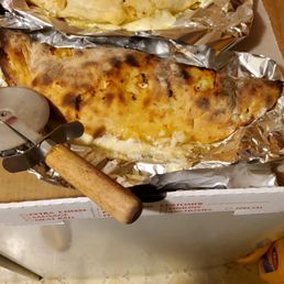 Opening the pizza box to delicious gluten free stromboli! Angela's pizza II did it!