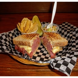 a corned beef sandwich with pickles a corned beef sandwich with pickles