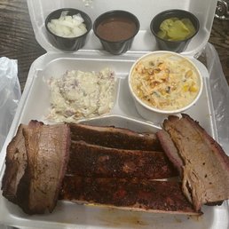 3 pieces of ribs and 4 slices of beef potato salad and corn 3 pieces of ribs and 4 slices of beef potato salad and corn