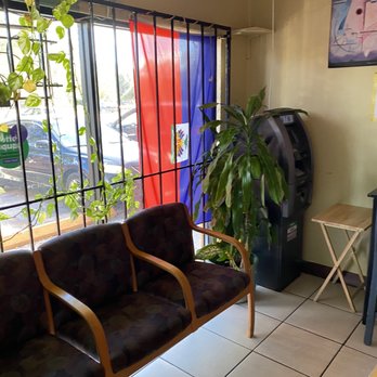 Sabine's Gout Creole - a living room with a couch and a coffee table - Haitian Near Me - Tampa, Florida