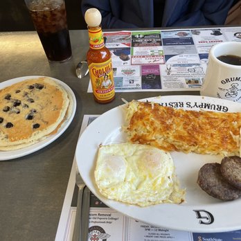 Grumpy's Restaurant - Big breakfast with 2 eggs over easy, sausage patties, hash browns, 2 blueberry pancakes and a coffee. All one price - Breakfast & Brunch Near Me - Orange Park, Florida