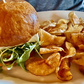 Virginia Inn - Halibut Sandwich: Grilled with arugula, pesto mayo, on a Macrina bun and house-made chips on the side... - Bars Near Me - Seattle, Washington