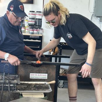 Aurora Borealis Glassworks - My husband trying glass blowing with Max, the instructor helped - Glass Blowing Near Me - Albuquerque, New Mexico