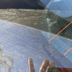 Shell - Upper part of back window on hatchback that was not clean after car wash, I tried to wipe it down a bit and reflection from the phone