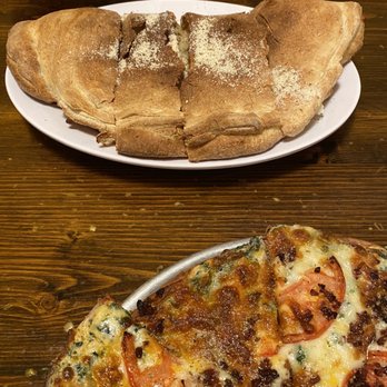 Mediterranean Restaurant & Cafe - Italian Stallion calzone in top of photo edge of my bacon tomato white pizza in foreground - Greek Near Me - Wilmington, Ohio Mediterranean Restaurant & Cafe - Italian Stallion calzone in top of photo edge of my bacon tomato white pizza in foreground - Greek Near Me - Wilmington, Ohio