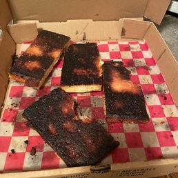 a box of burnt pizza a box of burnt pizza