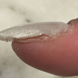 Elegant Nails & Tan - After 1 week, 2nd nail about to fall off.