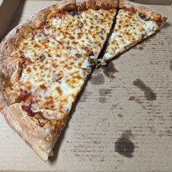Mad Mushroom - The pizza we ordered, visibly devoid of pepperoni. Slices missing because we were hoping to find some hiding under the cheese.
