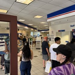US Post Office - 10:41AM on a Friday. Customer service line is backed-up to the front doors because the customer service clerks are slow & inefficient.