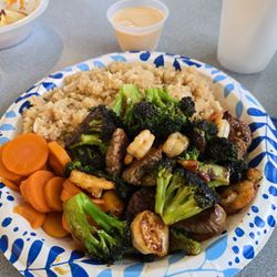Hibachi Steak, shrimp, and broccoli with teriyaki sauce, fried rice and carrots.