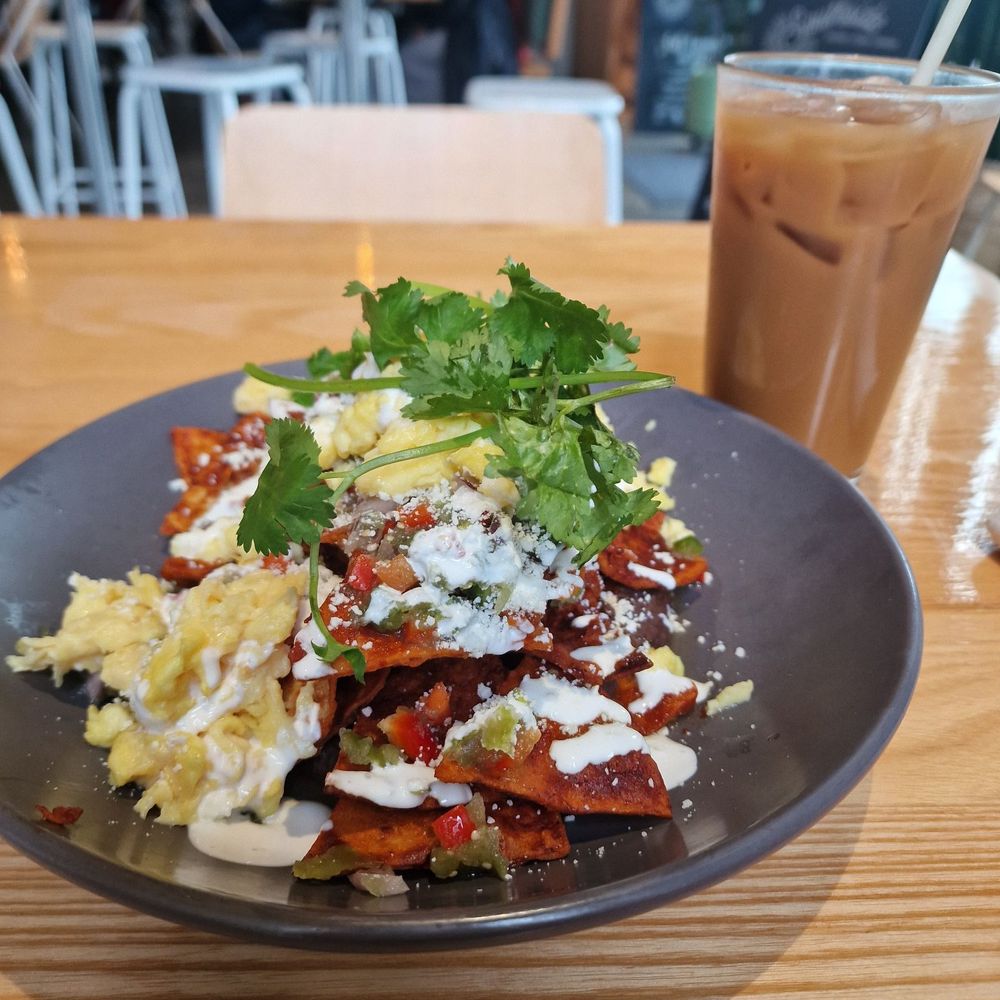 Chilaquiles with scrambled eggs. Iced Almond Horchata Latte Chilaquiles with scrambled eggs. Iced Almond Horchata Latte