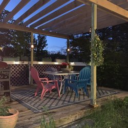 Outside deck with Pergola in the Bridgton Bungalow Cottage at the Denmark Stage Stop House in Denmark Maine complete with solar lighting.