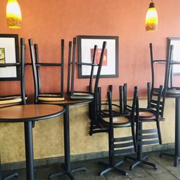 a row of chairs and tables in a restaurant