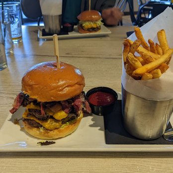 The Shores Restaurant - Double Smash Burger with Pastrami and grilled onions, Shires Fries on the side - New American Near Me - Oxnard, California The Shores Restaurant - Double Smash Burger with Pastrami and grilled onions, Shires Fries on the side - New American Near Me - Oxnard, California