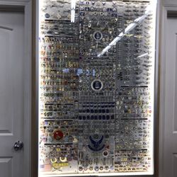 Army Navy Marine Store - Wall of various lapel pins.
