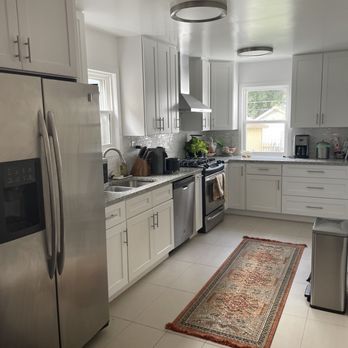 Tony’s Contracting Group - a kitchen with white cabinets and stainless steel appliances - General Contractors Near Me Tony’s Contracting Group - a kitchen with white cabinets and stainless steel appliances - General Contractors Near Me