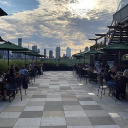 City Vineyard - Plenty of room to spread out, enjoy a cocktail or glass of wine by the water, and get some much needed fresh air on our extended patio!