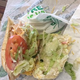 a sandwich with lettuce, tomato, and cheese