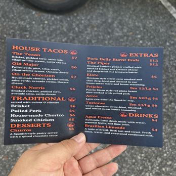 Smokin Taqueria - a hand holding a menu - Food Trucks Near Me - Jacksonville, Florida