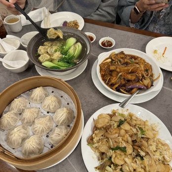 Dumpling Bites - Steamed Pork XLB (left), Stir-Fried Rice Cake (right), Wonton Noodle Soup (top left), and Eggplant with Garlic Sauce (top right) - Noodles Near Me - San Francisco, California Dumpling Bites - Steamed Pork XLB (left), Stir-Fried Rice Cake (right), Wonton Noodle Soup (top left), and Eggplant with Garlic Sauce (top right) - Noodles Near Me - San Francisco, California