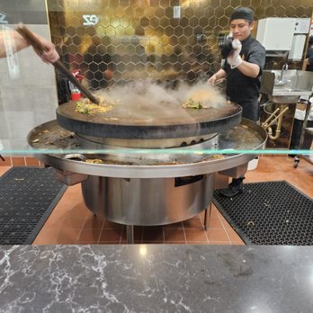 Gengis Khan - a man preparing food in a kitchen - Mongolian Near Me - Santa Rosa, California Gengis Khan - a man preparing food in a kitchen - Mongolian Near Me - Santa Rosa, California