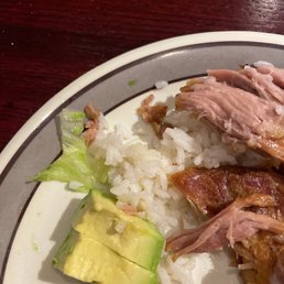 Chicharon, white rice and avocado are pictured. Their lemon pickled onions were delicious.