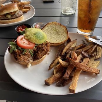 Acres Bistro - Crispy California: crispy chicken, arugula, avocado, tomato, goat cheese & chipotle aioli on brioche bun - American Near Me - Rochelle, Illinois