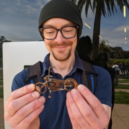 My very happy bf holding the tiny motorcycle Bob gifted me.