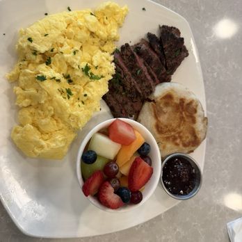 The Serve - Steak (medium rare) and eggs with English muffin and fruit. - American Near Me - Cornelius, North Carolina The Serve - Steak (medium rare) and eggs with English muffin and fruit. - American Near Me - Cornelius, North Carolina