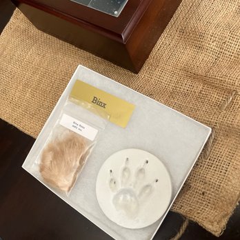 Mobile Pet Cremations - Photo urn with cremains inside, name plate, his fur, & paw print - Pet Cremation Services Near Me Mobile Pet Cremations - Photo urn with cremains inside, name plate, his fur, & paw print - Pet Cremation Services Near Me
